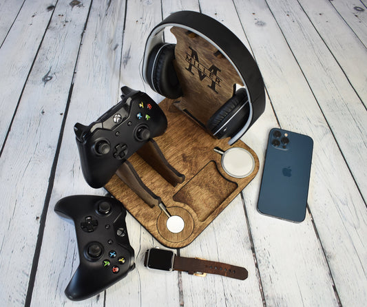 A headphones and controller stand with an iwatch and a magsafe charger.